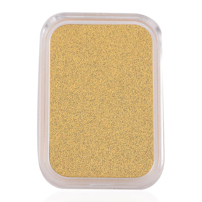 Rectangular container of gold-colored powder on a white background