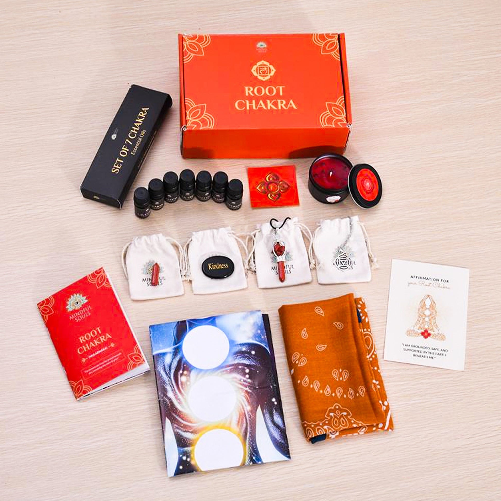 Root Chakra product set with packaging and accessories on a wooden surface