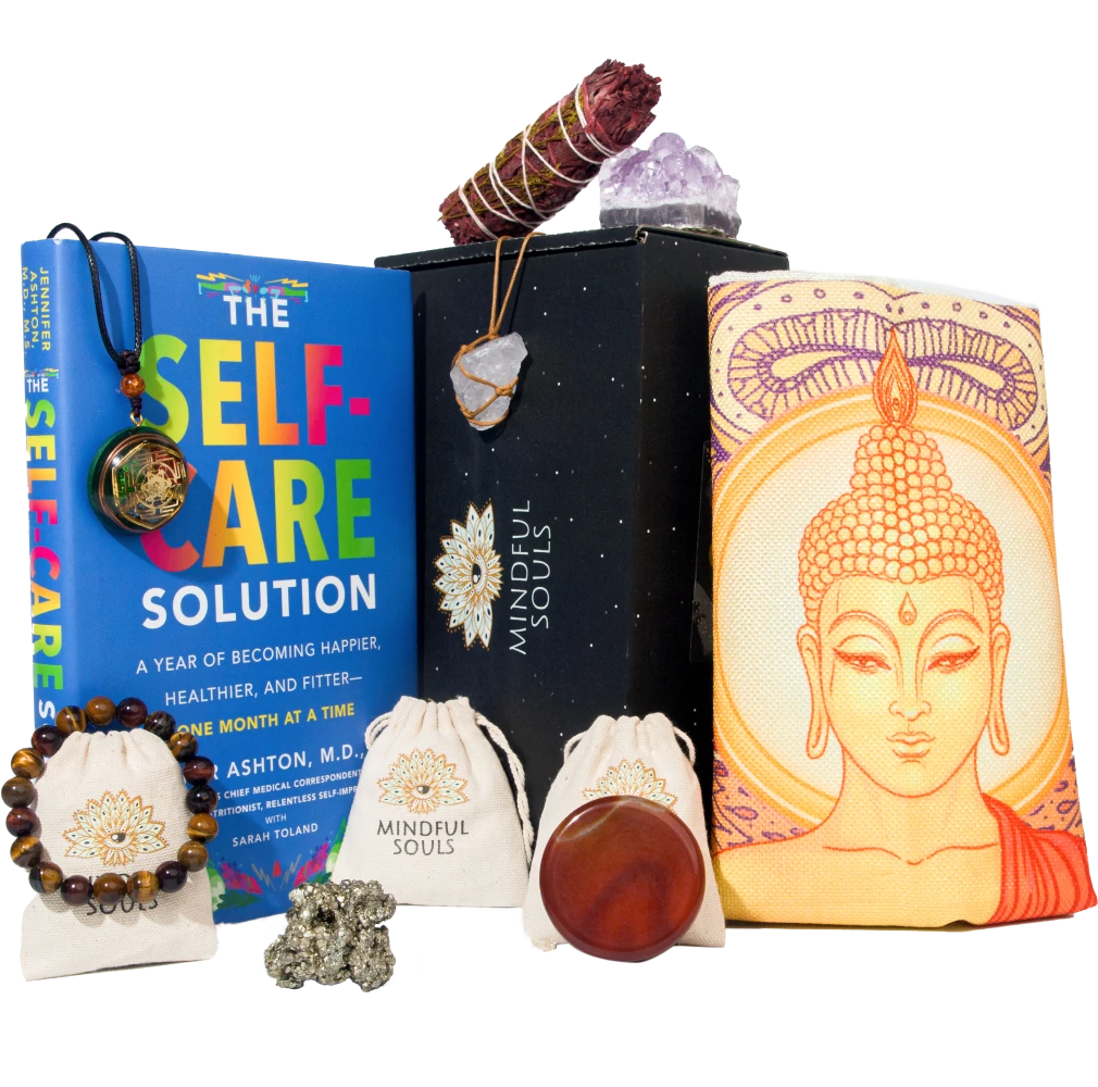 Mindful Souls subscription box with assorted spiritual items including healing crystals, jewelry, essential oils, and mindfulness accessories arranged in an open black box.