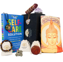 Mindful Souls subscription box with assorted spiritual items including healing crystals, jewelry, essential oils, and mindfulness accessories arranged in an open black box.
